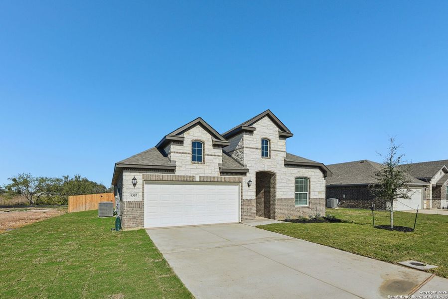 Front exterior of a new home in Carmel Ranch, Schertz, TX, highlighting curb appeal (Image 25).