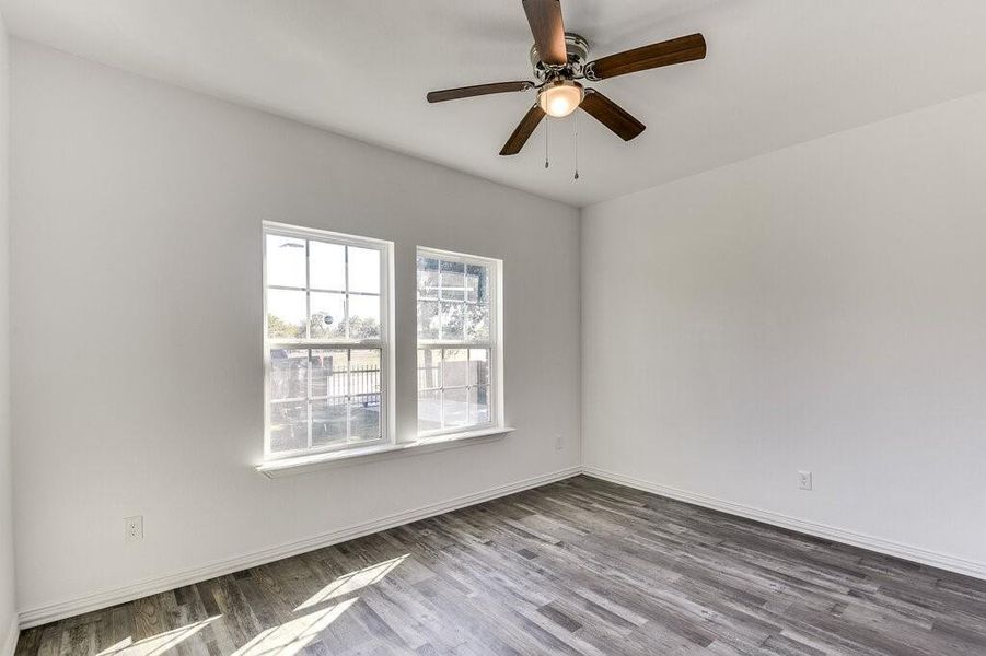 Unfurnished room featuring wood-type flooring and ceiling fan