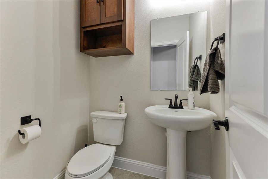 Crisp and clean half bathroom with white pedestal skin Crisp and clean half bathroom with white pedestal skin