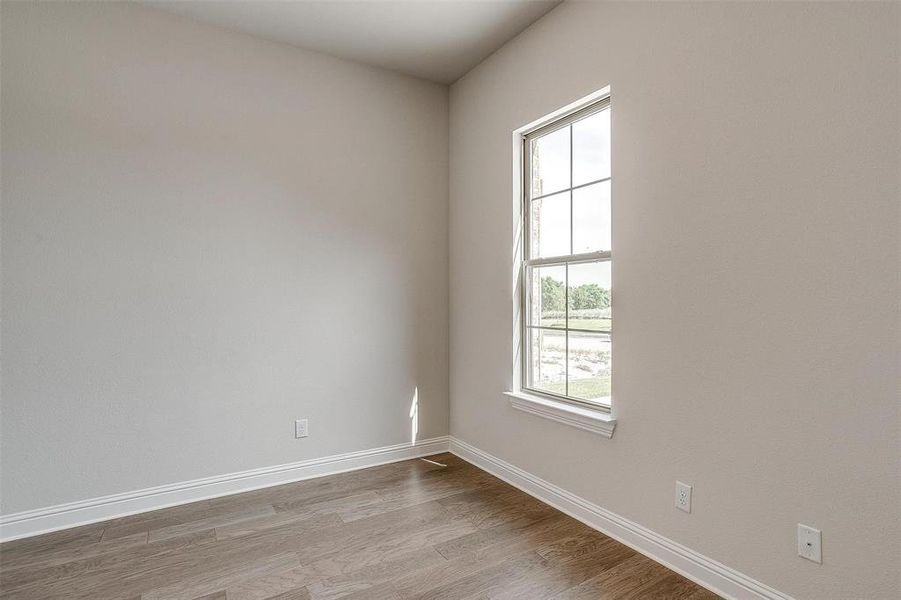 Empty room featuring light hardwood / wood-style floors and a healthy amount of sunlight