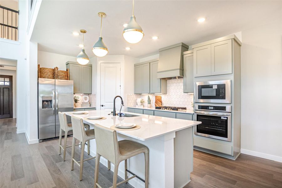 Modern kitchen with sleek cabinetry, stainless steel appliances, and a spacious island with seating. The space features and a clean, open layout perfect for entertaining. Modern kitchen with sleek cabinetry, stainless steel appliances, and a spacious island with seating. The space features and a clean, open layout perfect for entertaining.