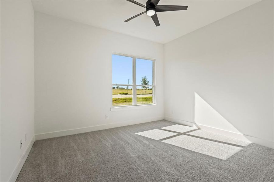 Spare room featuring carpet floors and ceiling fan Spare room featuring carpet floors and ceiling fan