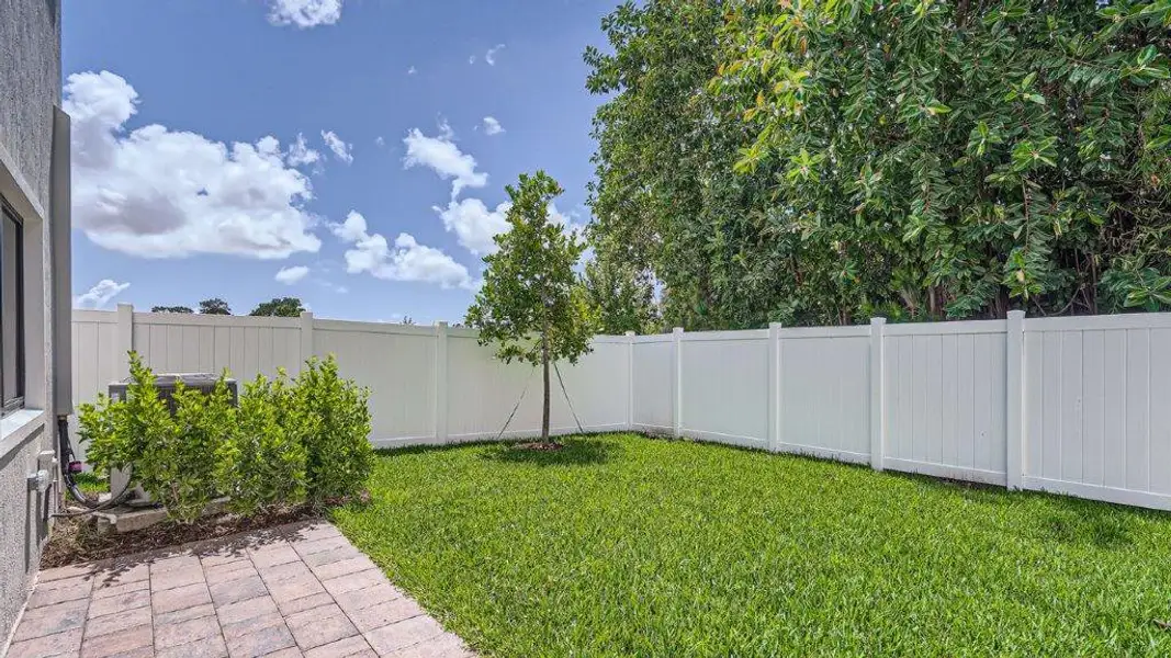Exterior details and patio area of a home in Ashwood Cove, Lake Worth (Image 4).