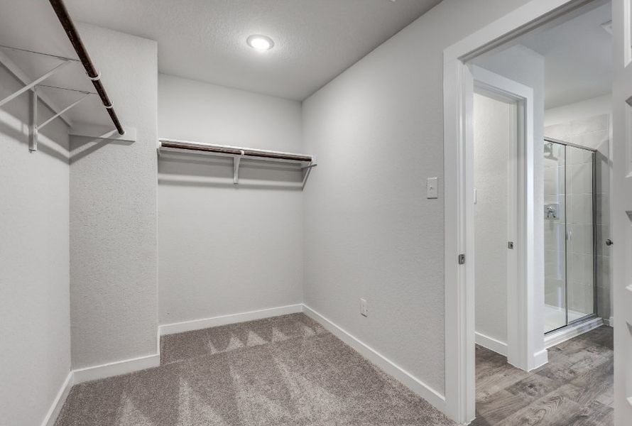 A room with a glass door and a glass shower.