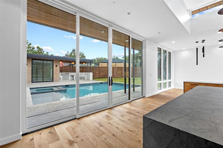 The pool becomes a central focus of of the home orientation as the whole structure wraps around the pool