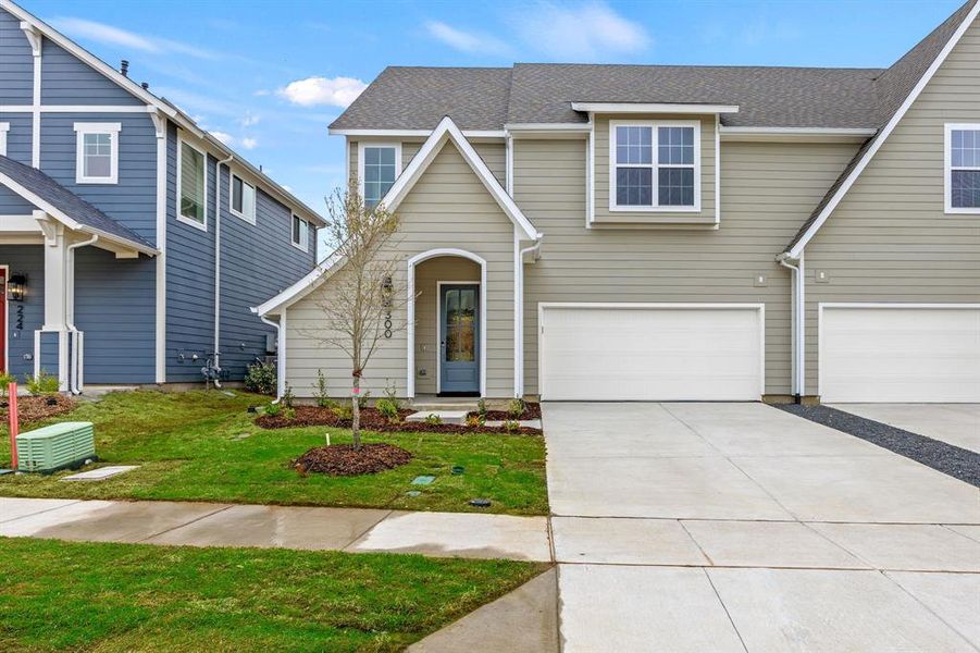 Front exterior of a new home in North Square at Uptown, Celina, TX, highlighting curb appeal (Image 2).