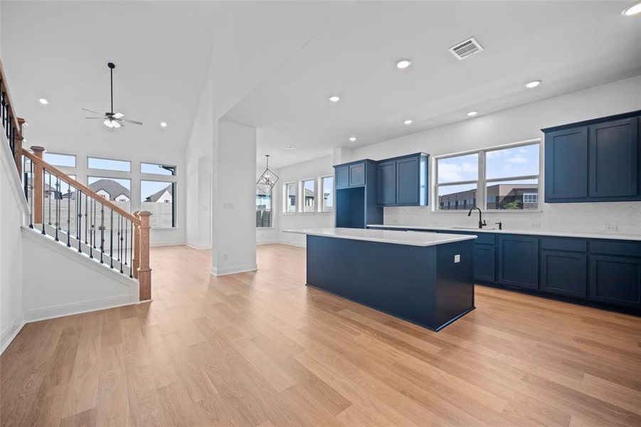 Kitchen featuring a kitchen island, light hardwood / wood-style floors, and decorative backsplash