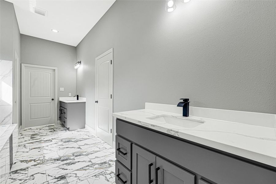 Spa like bath offers double sinks and quartz counter tops. Spa like bath offers double sinks and quartz counter tops.