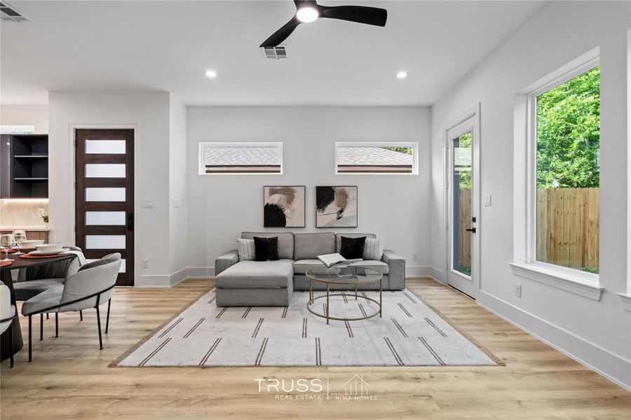 High ceilings and corner windows amplify natural light, enhancing a sense of openness and calm.