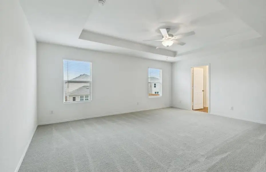 Elegant owner's suite with Tray ceiling *real home pictured