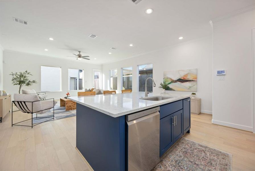 Designed for functionality and style, with custom cabinetry and pre-wired for pendant lighting over the island, this kitchen opens to the welcoming den.