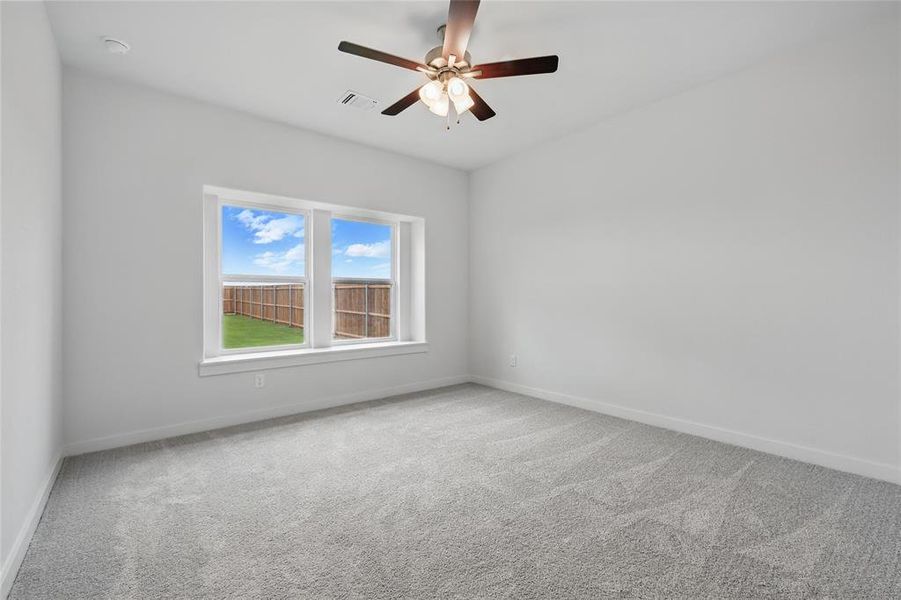 Empty room with carpet floors, a ceiling fan, and baseboards Empty room with carpet floors, a ceiling fan, and baseboards