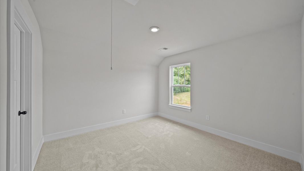 Superior comfort in this light-filled bedroom with plush carpeting and thoughtfully placed large windows
