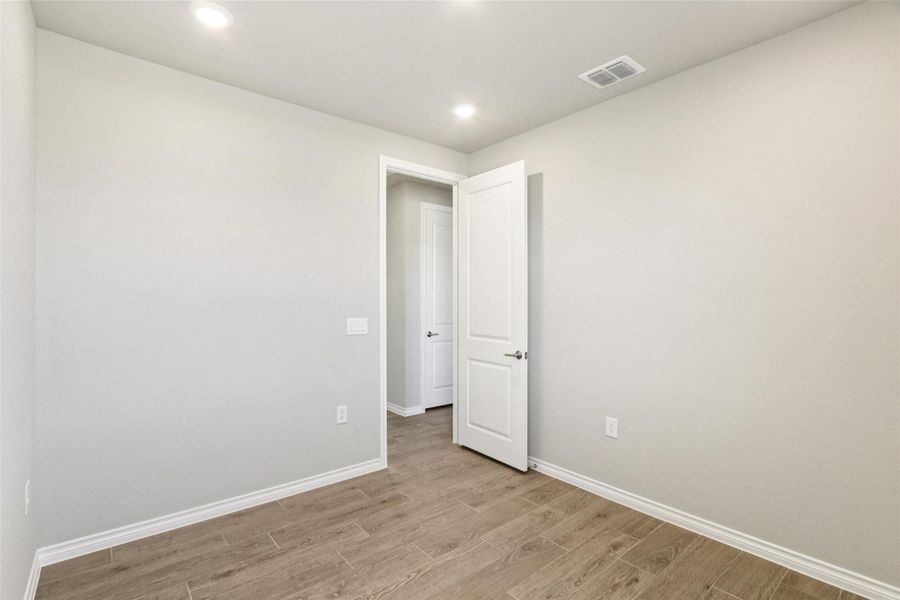 Unfurnished room with light wood-style floors and recessed lighting