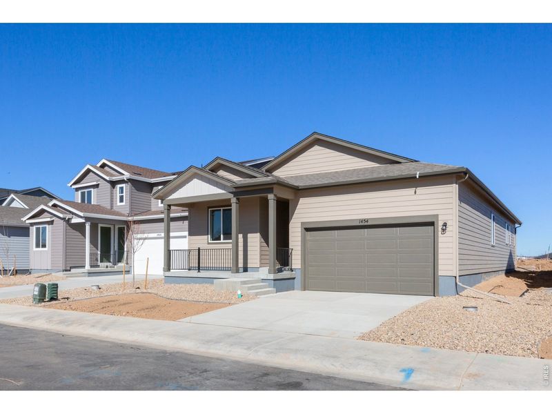 Front exterior of a new home in Trevenna, Windsor, CO, highlighting curb appeal (Image 14). Front exterior of a new home in Trevenna, Windsor, CO, highlighting curb appeal (Image 14).