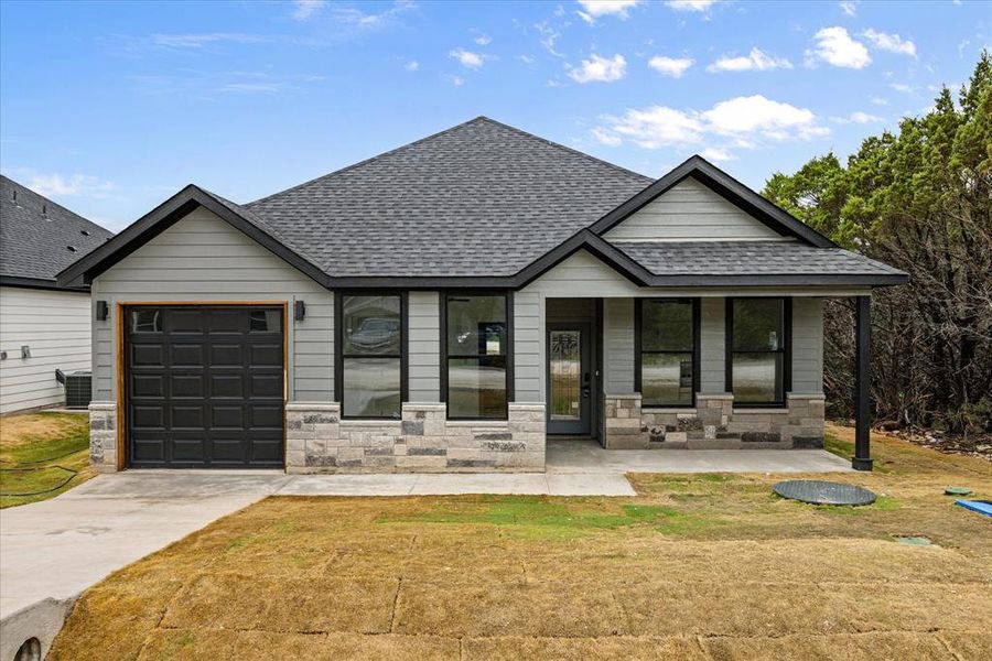 Front exterior of a new home in , Granbury, TX, highlighting curb appeal (Image 2).