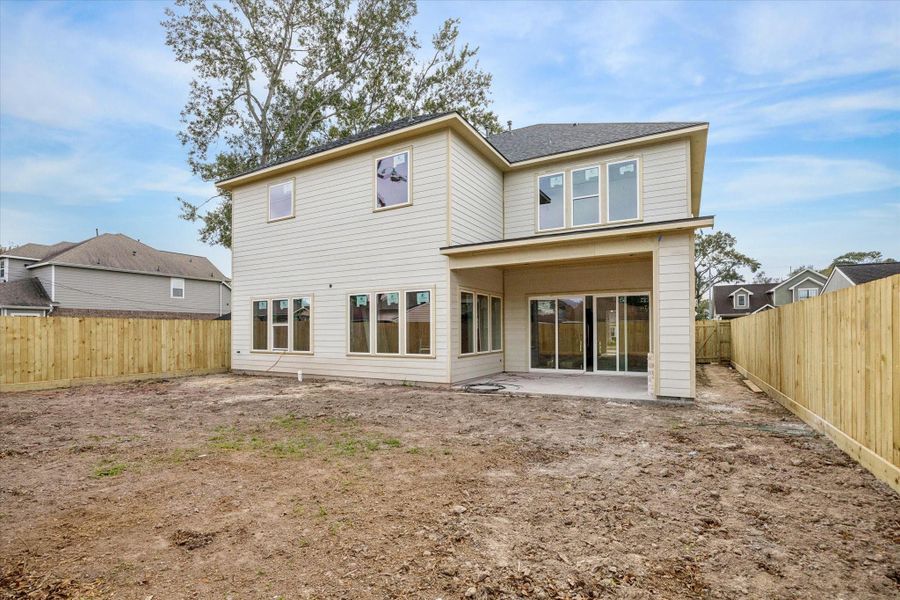 A fenced backyard offers generous green space with room to play, entertain, or design a future pool or outdoor retreat.