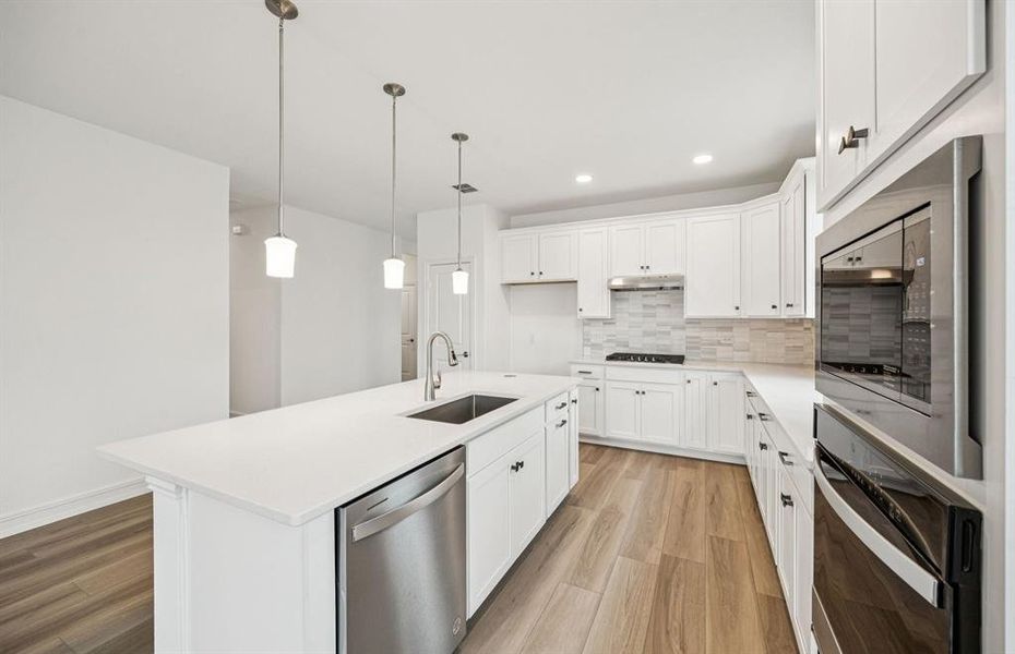 High-end gourmet kitchen with premium finishes and upgraded appliances *Real home pictured