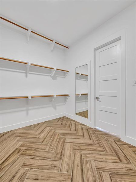 Spacious closet featuring parquet flooring