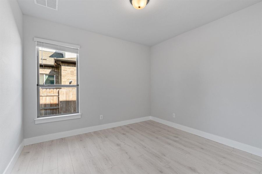 Unfurnished room featuring light wood-style floors and baseboards