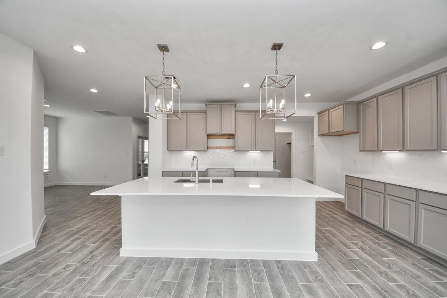 This kitchen is by far any chef’s dream! This spacious kitchen features high ceilings, stained wood cabinets, granite countertop, SS appliances, modern tile backsplash, recessed lighting, extended counter space, granite kitchen island with double sink, and space for breakfast bar, and a walk-in pantry all overlooking your huge family room. This kitchen is by far any chef’s dream! This spacious kitchen features high ceilings, stained wood cabinets, granite countertop, SS appliances, modern tile backsplash, recessed lighting, extended counter space, granite kitchen island with double sink, and space for breakfast bar, and a walk-in pantry all overlooking your huge family room.