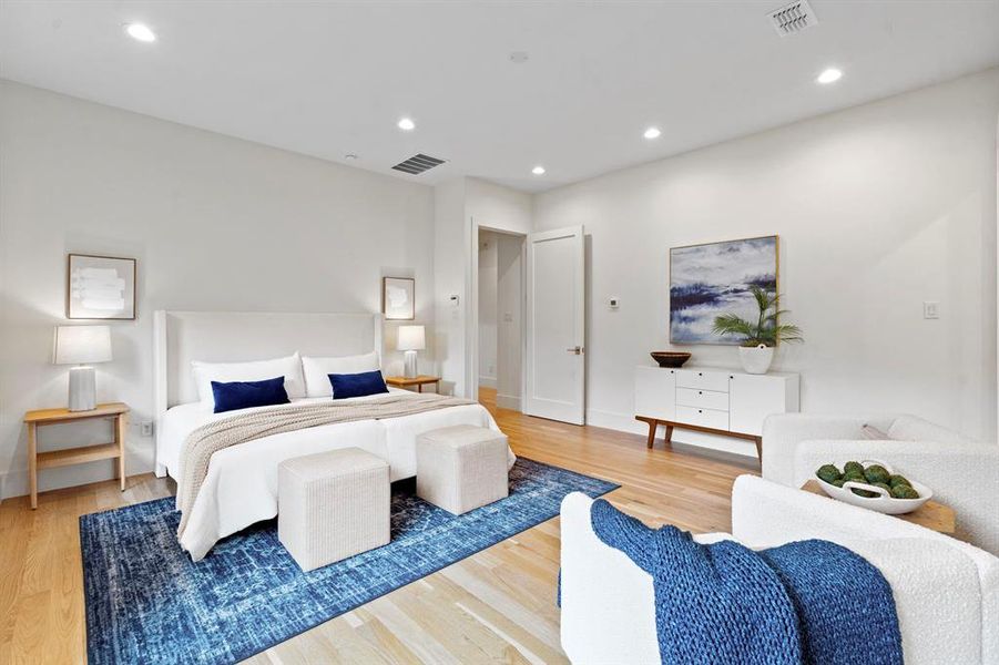 Bedroom with light wood-type flooring and recessed lighting Bedroom with light wood-type flooring and recessed lighting