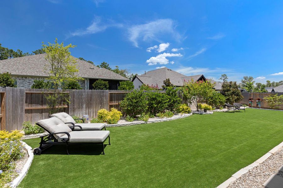 The spacious backyard features lush landscaping and high-quality turf, providing a pristine and low-maintenance outdoor space.