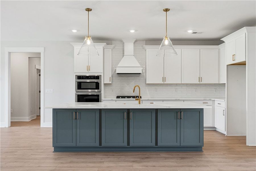 A luminous kitchen island anchors this cooking spa A luminous kitchen island anchors this cooking spa