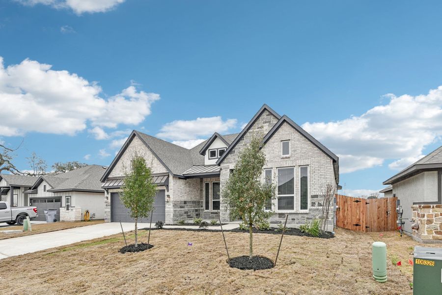 Front exterior of a new home in Village at Three Oaks, Seguin, TX, highlighting curb appeal (Image 26). Front exterior of a new home in Village at Three Oaks, Seguin, TX, highlighting curb appeal (Image 26).