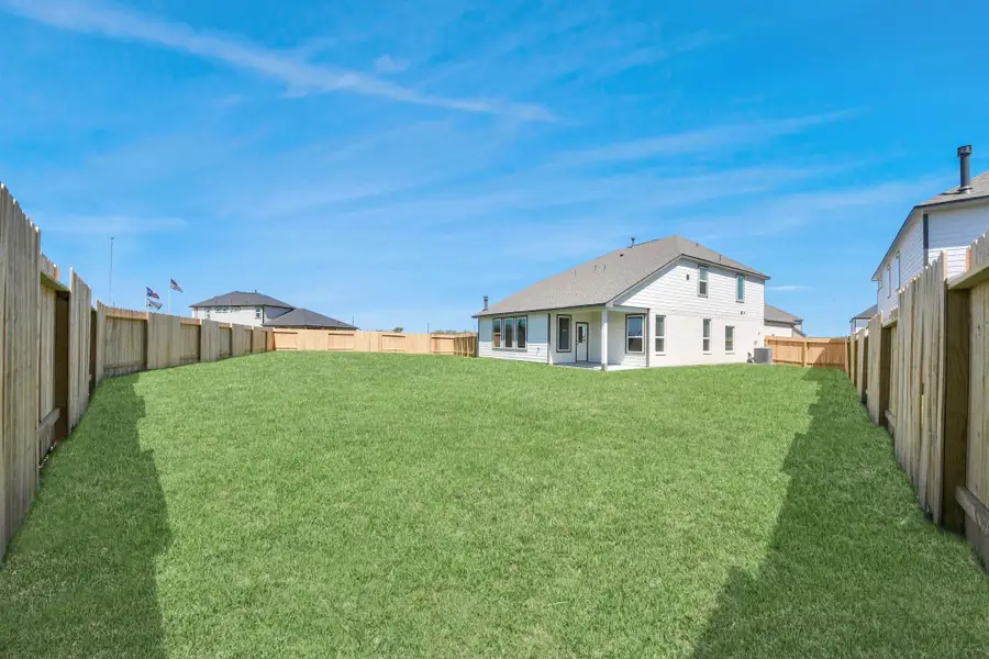 Explore the expansive backyard with its inviting covered patio—a perfect blend of space for the kids to play and adults to unwind. Ideal for creating your outdoor oasis, this backyard accommodates patio furniture, a BBQ pit, and endless possibilities for leisure and entertainment. Sample photo of completed home with similar floor plan. Actual colors and selections may vary. Explore the expansive backyard with its inviting covered patio—a perfect blend of space for the kids to play and adults to unwind. Ideal for creating your outdoor oasis, this backyard accommodates patio furniture, a BBQ pit, and endless possibilities for leisure and entertainment. Sample photo of completed home with similar floor plan. Actual colors and selections may vary.