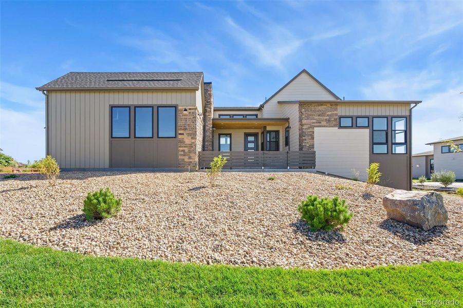 Front exterior of a new home in Acadia at RainDance, Windsor, CO, highlighting curb appeal (Image 13).