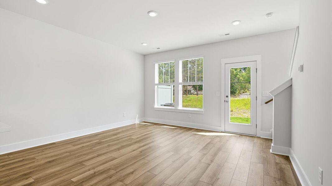 First-rate family room with thoughtful layout and superior connection to kitchen and dining spaces by DRB Homes