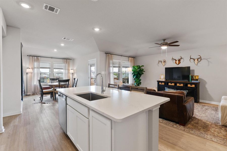 Spacious kitchen island with a single-basin sink and stainless steel faucet Spacious kitchen island with a single-basin sink and stainless steel faucet