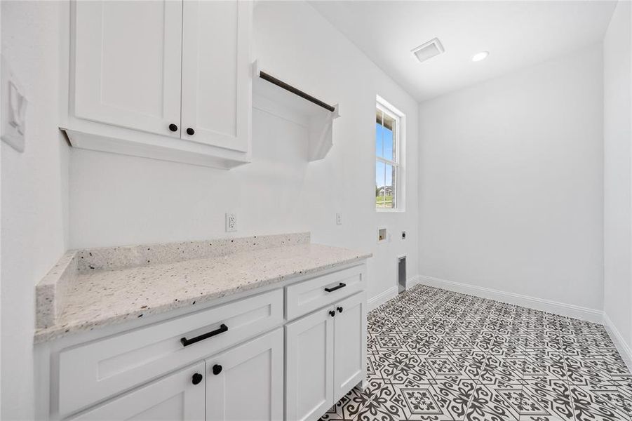 Laundry area featuring hookup for a washing machine, cabinet space, hookup for an electric dryer, and recessed lighting