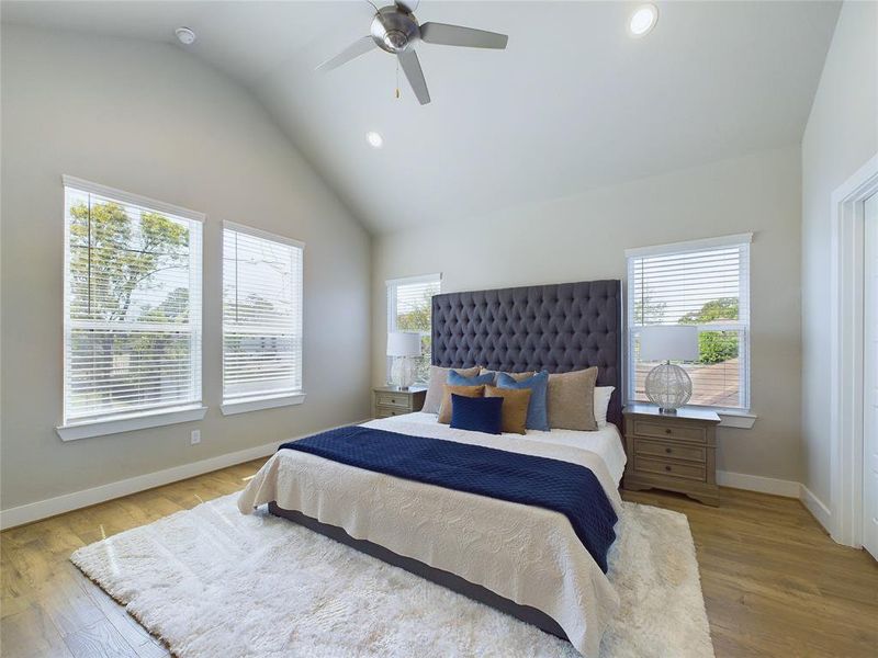 Primary bedroom has a vaulted ceiling