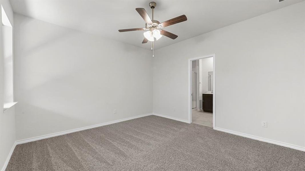 Unfurnished room with carpet flooring and a ceiling fan
