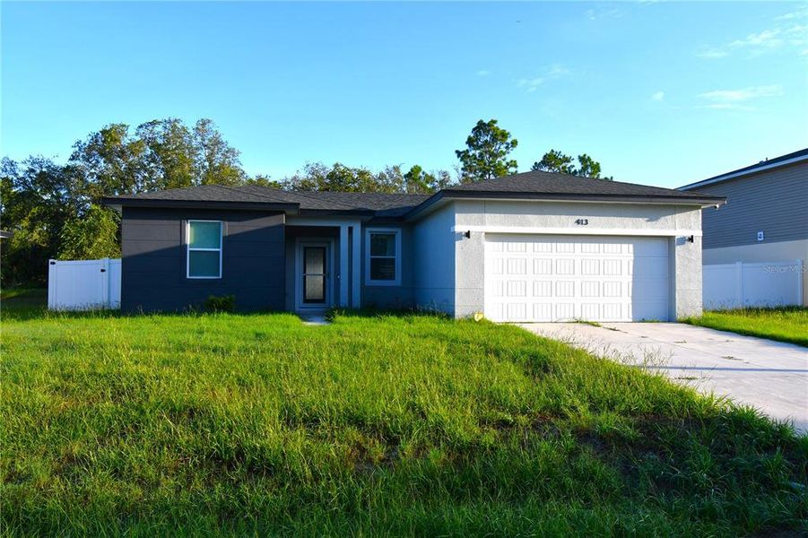Front exterior of a new home in , Poinciana, FL, highlighting curb appeal (Image 1). Front exterior of a new home in , Poinciana, FL, highlighting curb appeal (Image 1).