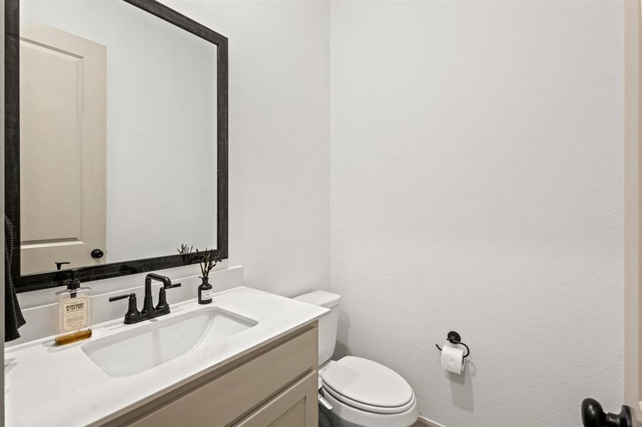 Bathroom featuring vanity and a textured wall