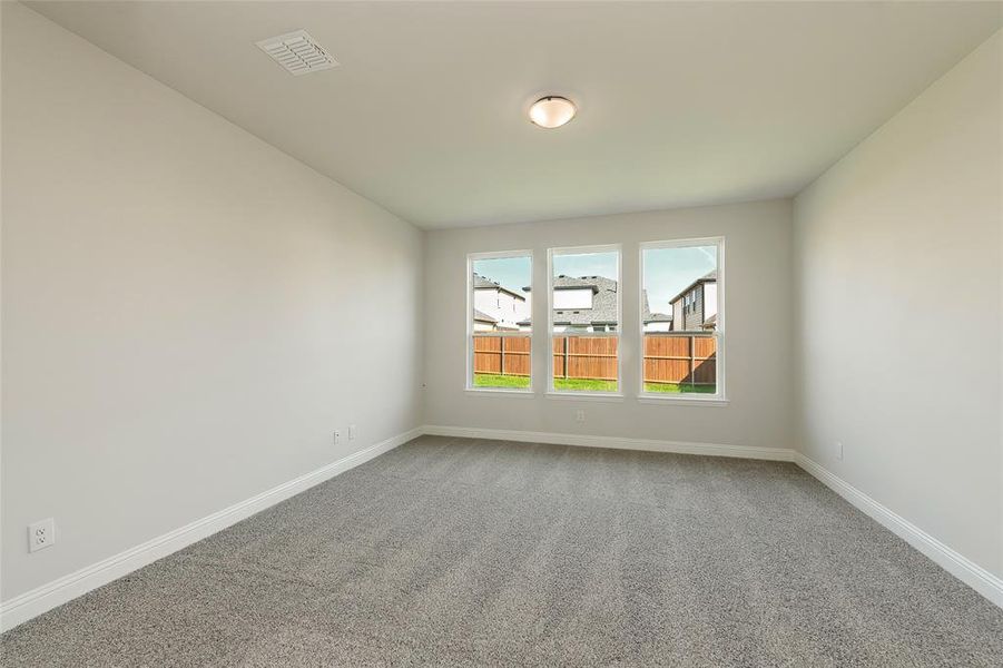 Carpeted empty room featuring baseboards Carpeted empty room featuring baseboards