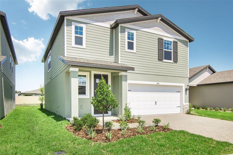 Front exterior of a new home in Two Rivers - Premier Series, Zephyrhills, FL, highlighting curb appeal (Image 2). Front exterior of a new home in Two Rivers - Premier Series, Zephyrhills, FL, highlighting curb appeal (Image 2).