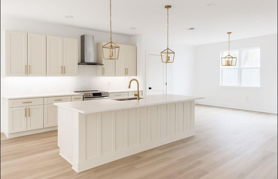 Kitchen with tasteful backsplash, under cabinet lighting, wall chimney exhaust hood, decorative light fixtures, a center island with sink, and stainless steel electric range