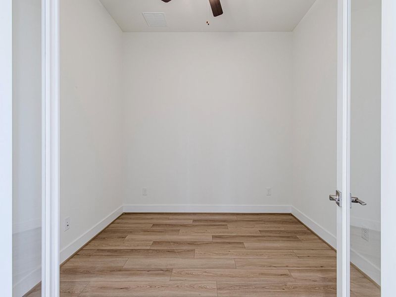 Additional bedroom or flex room with wood flooring.
