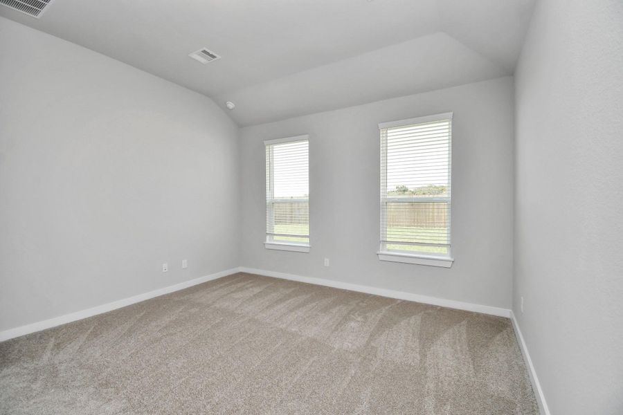 Retreat to the luxurious primary suite, your perfect escape for unwinding after a long day. Located on the first floor, this spacious room features plush carpeting, calming paint tones, high ceilings, and large windows with privacy blinds. Retreat to the luxurious primary suite, your perfect escape for unwinding after a long day. Located on the first floor, this spacious room features plush carpeting, calming paint tones, high ceilings, and large windows with privacy blinds.