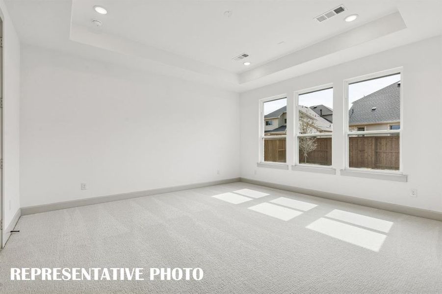 Located at the rear of the home for additional privacy, this peaceful owner's suite is the perfect place to relax and renew.  REPRESENTATIVE PHOTO