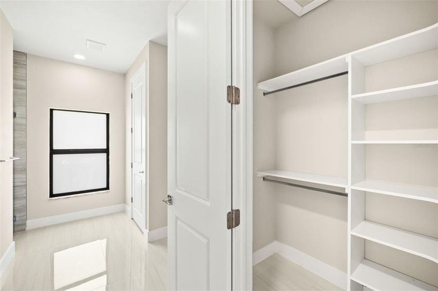 First Primary Walk-In Closet with Built-In Shelving First Primary Walk-In Closet with Built-In Shelving