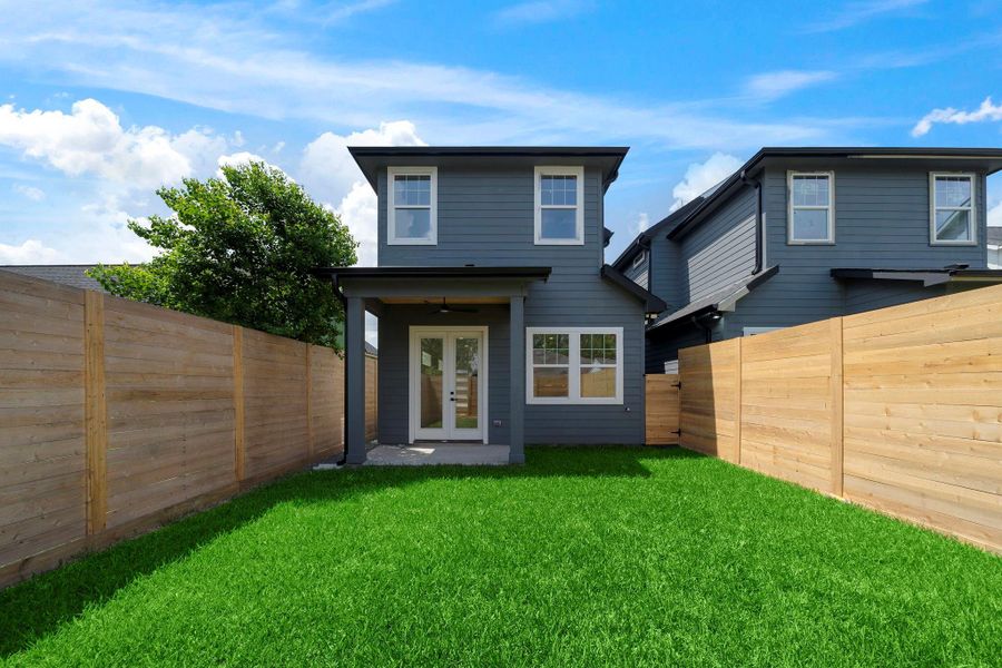 Charming two-story home with a modern gray facade, featuring a well-maintained backyard enclosed by wooden fencing. Perfect for outdoor relaxation and privacy. Charming two-story home with a modern gray facade, featuring a well-maintained backyard enclosed by wooden fencing. Perfect for outdoor relaxation and privacy.