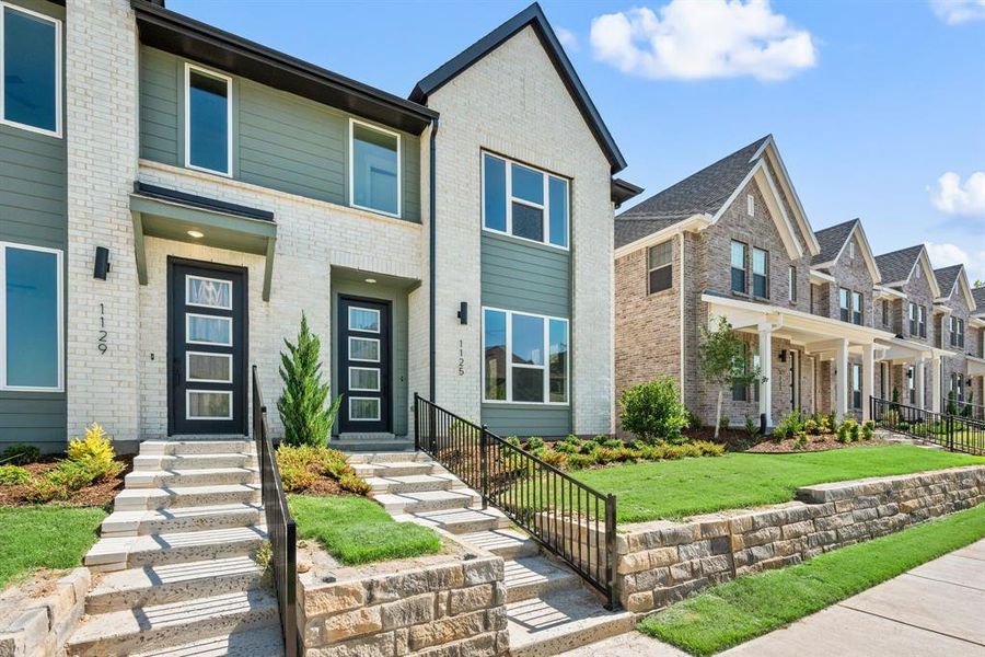 Featuring a welcoming entrance with white brick, striking trim and lush landscaping, our end unit Alexander plan offers fantastic curb appeal! Featuring a welcoming entrance with white brick, striking trim and lush landscaping, our end unit Alexander plan offers fantastic curb appeal!