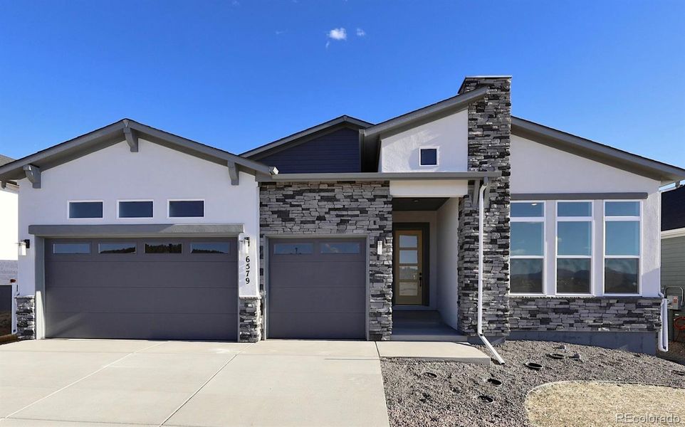 Front exterior of a new home in Wolf Ranch - Enclave Collection, Colorado Springs, CO, highlighting curb appeal (Image 1).