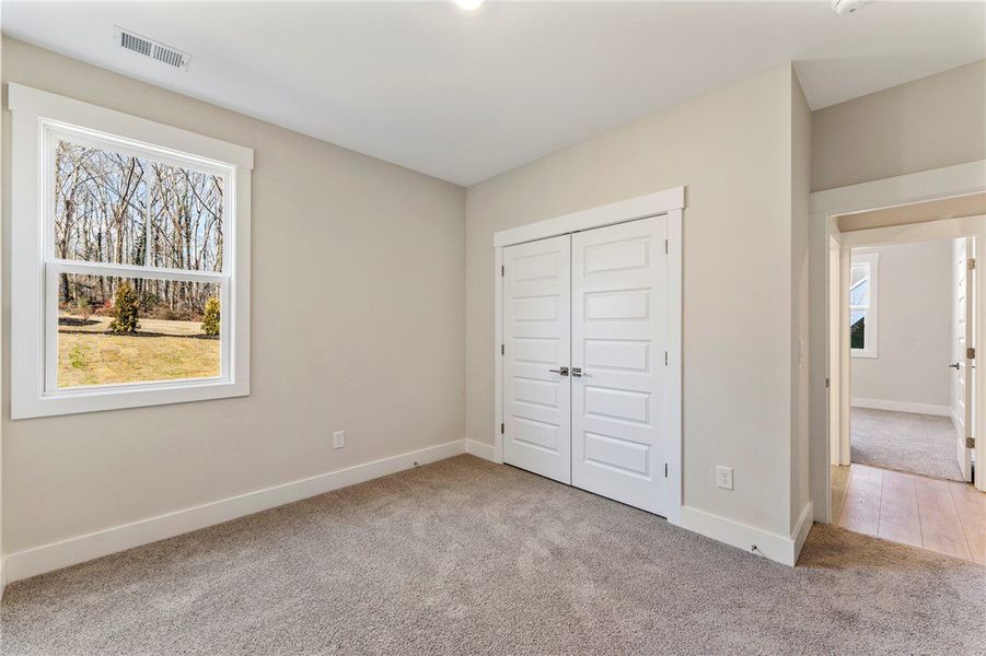 This inviting bedroom features soft carpeting, a b This inviting bedroom features soft carpeting, a b