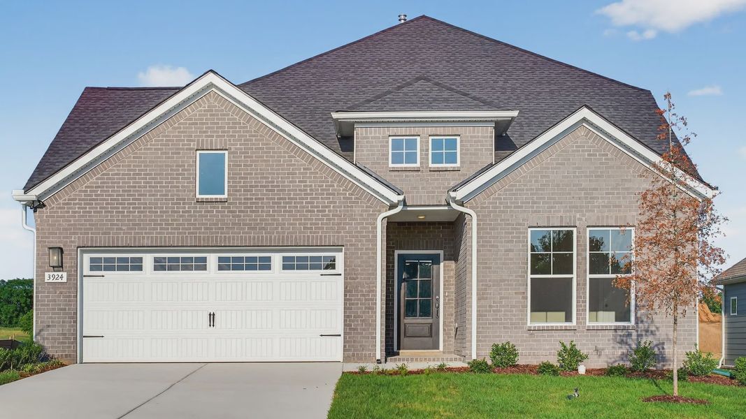Elegant brick facade with expansive garage, steep gable roof at McClure Farms. Elegant brick facade with expansive garage, steep gable roof at McClure Farms.